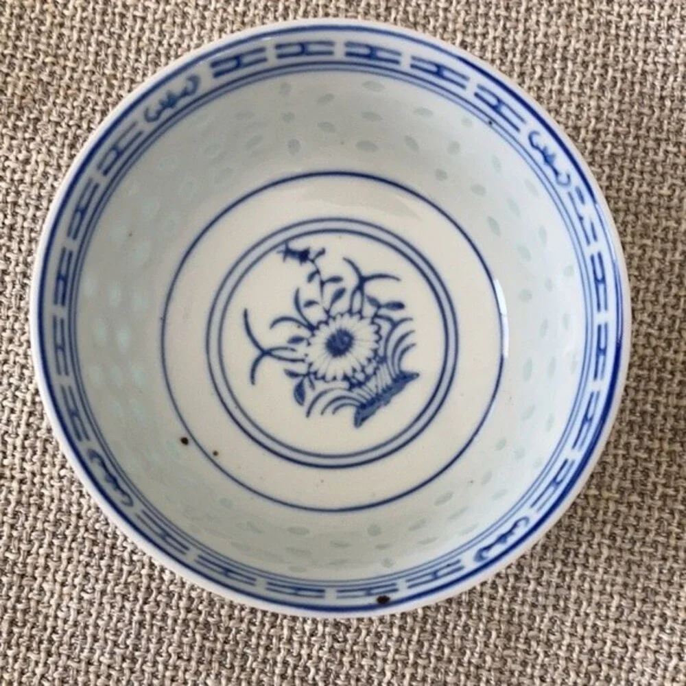 Small Chinese blue white porcelain bowl with brown glaze specks.